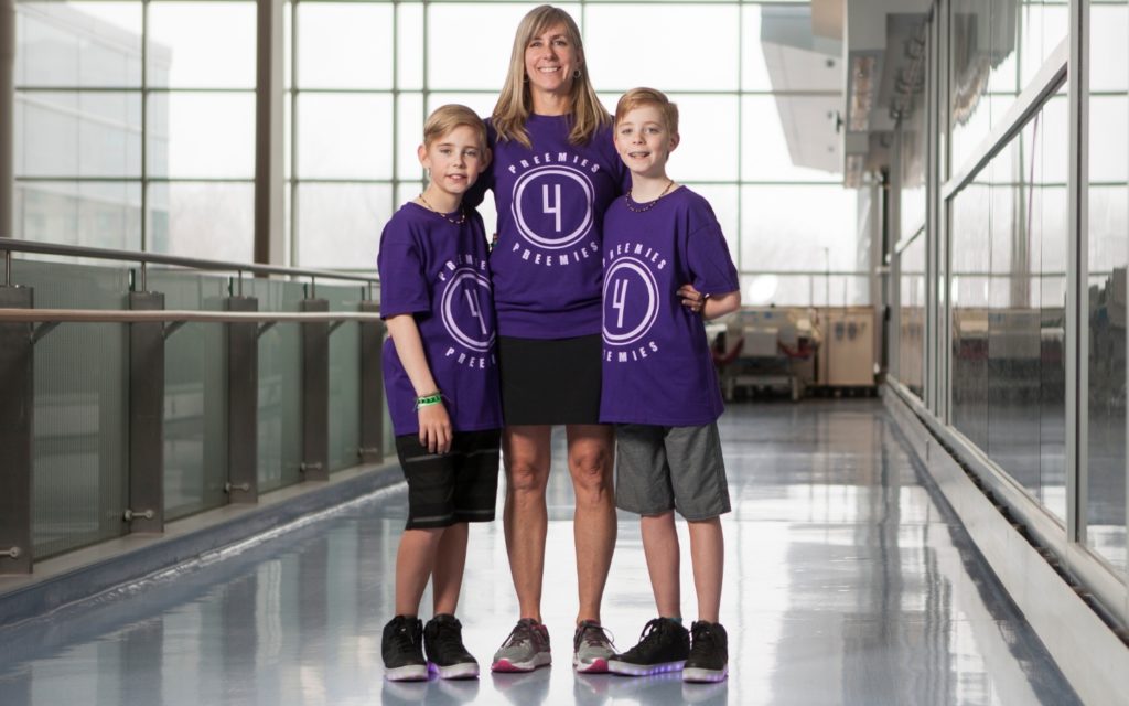 Nora, Liam, and Rhys Shipton smile wearing their Preemies for Preemies team shirts