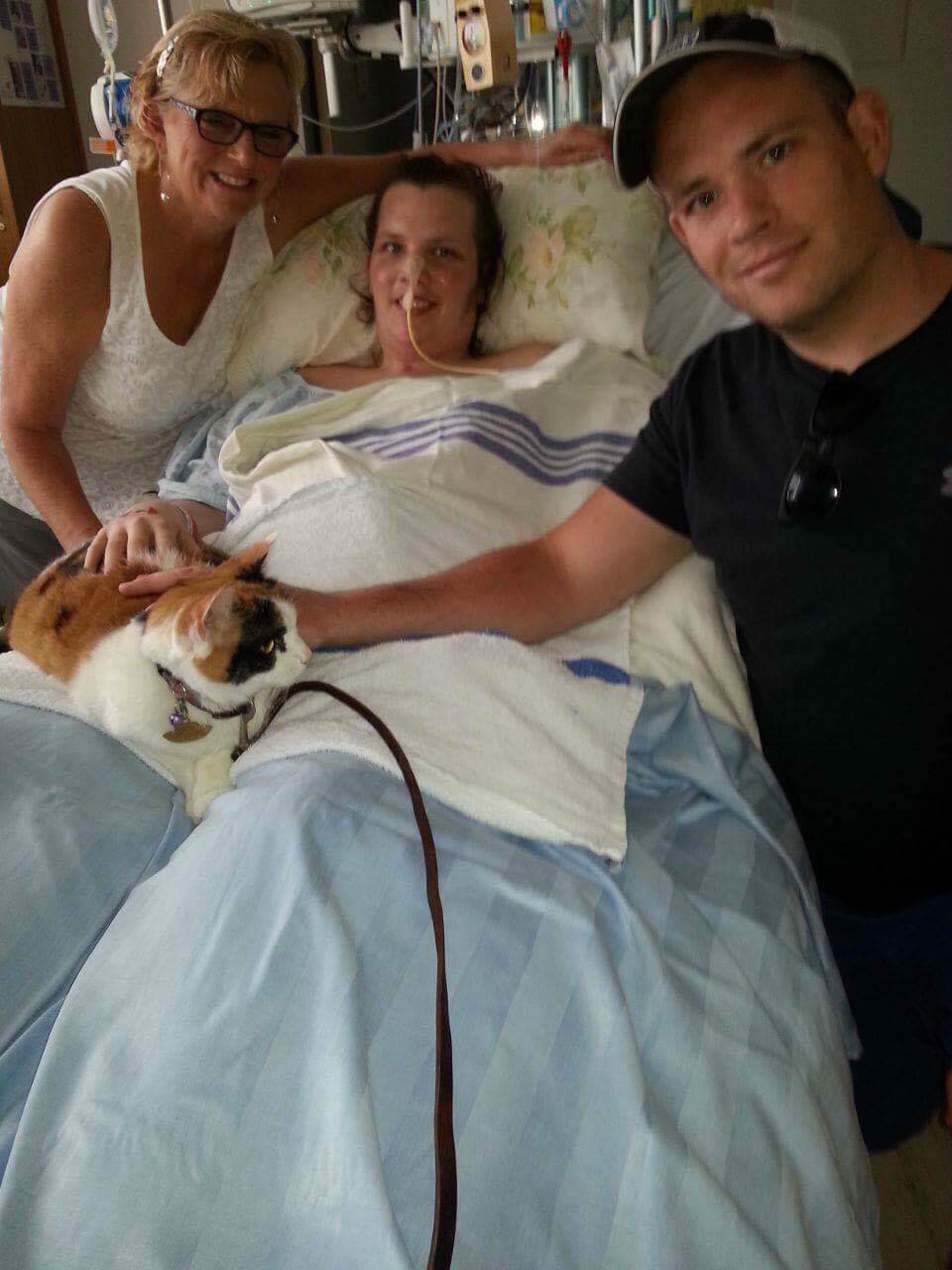 Ashley Ruelland lying in hospital bed