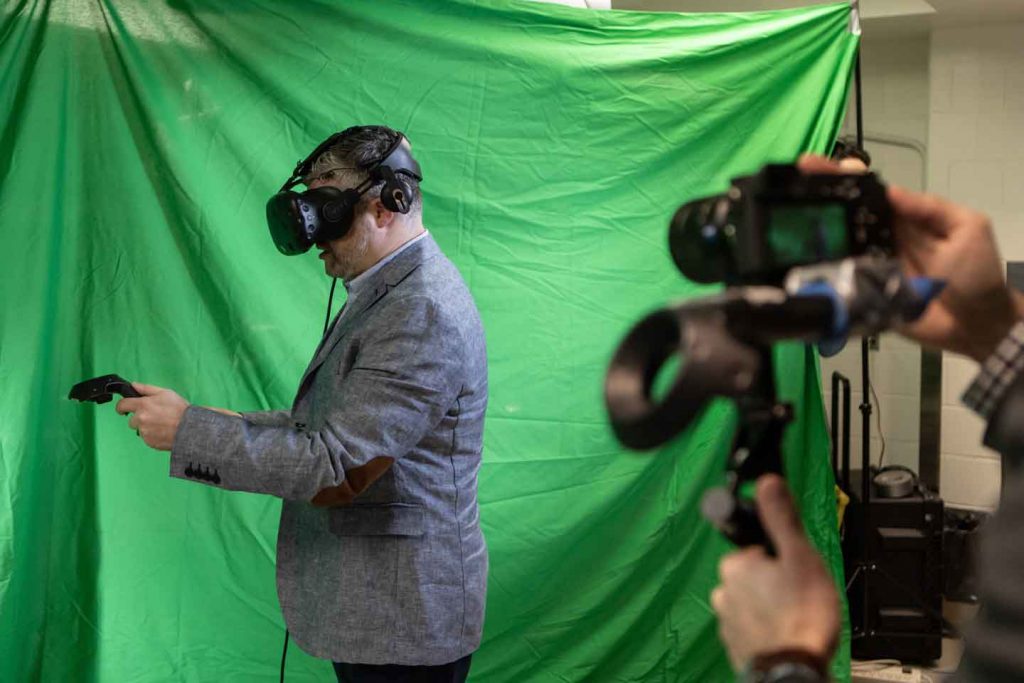 Dr. Adam Sachs holding 3D virtual reality wands.