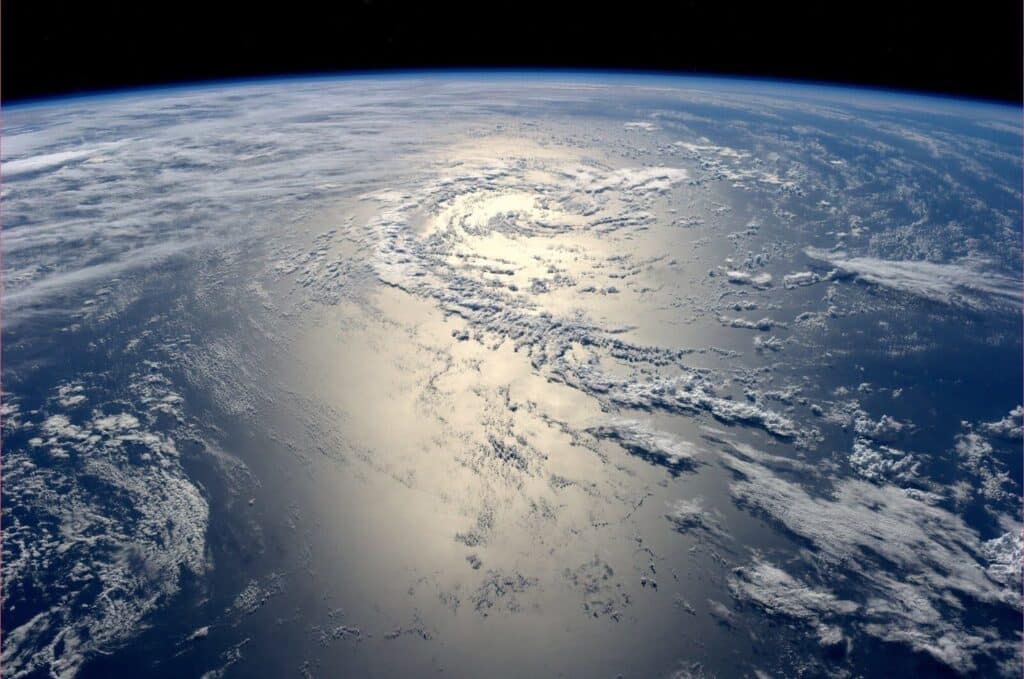 The curve of Earth seen from the International Space Station, sunlight reflecting off the ocean